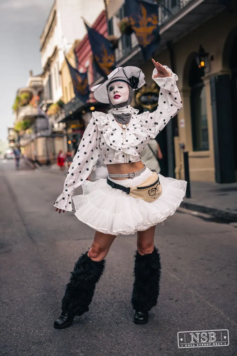 Costumed street performer posing on Royal Street during Dirty Linen Night 2026 in New Orleans