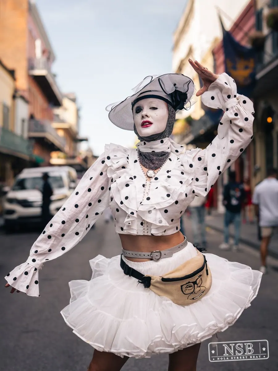 Portrait of a theatrical street performer at Dirty Linen Night 2026 in the French Quarter