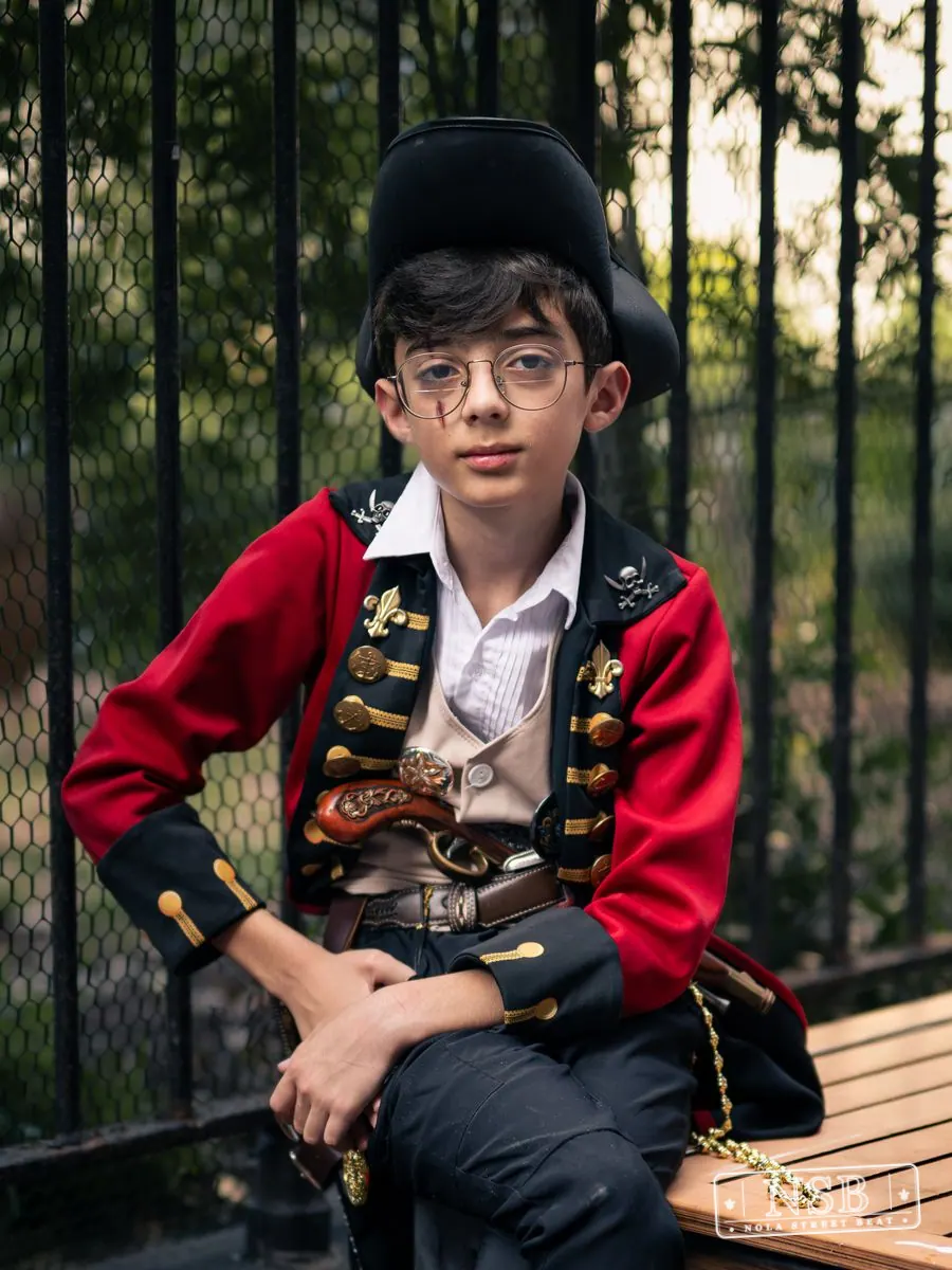 Young attendee in a vintage-inspired costume at Dirty Linen Night 2026 on Royal Street