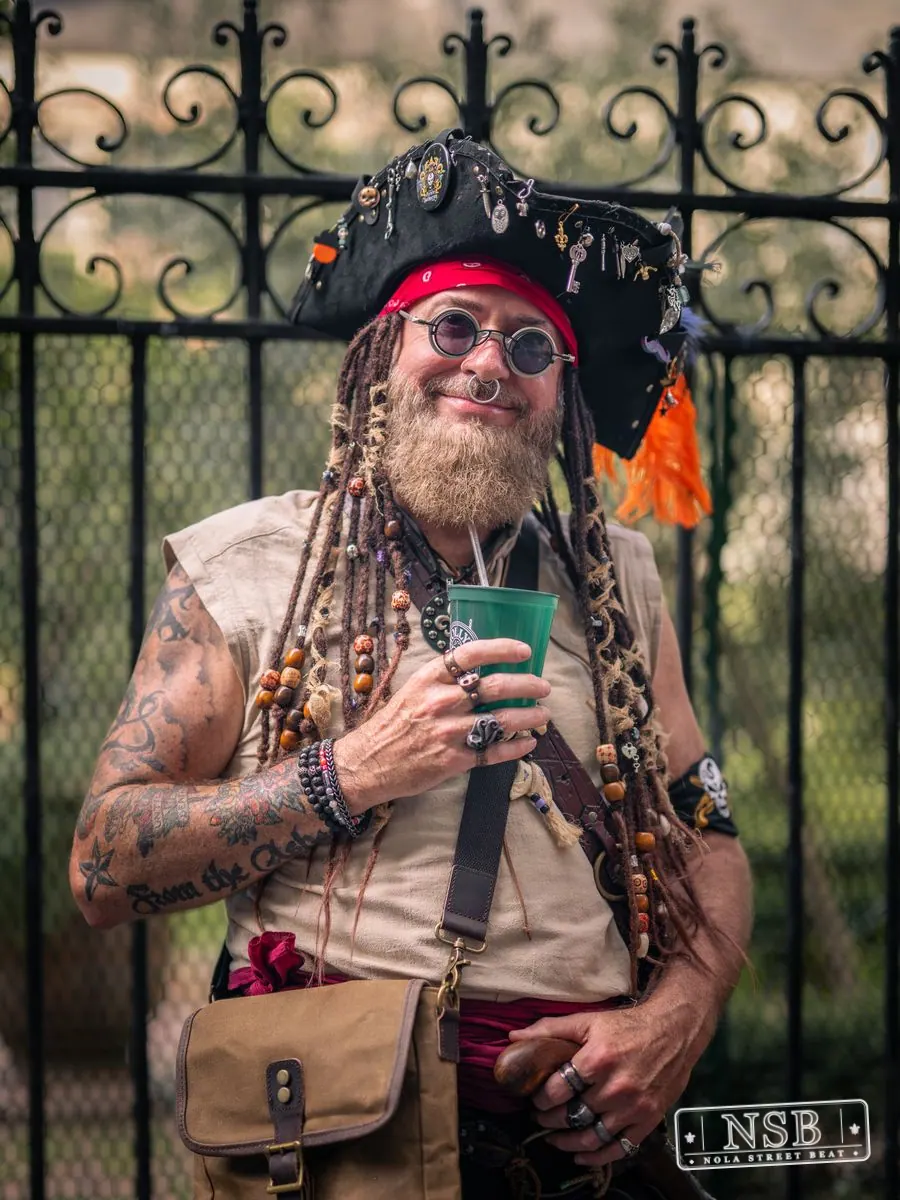 Attendee in a pirate costume holding a drink at Dirty Linen Night 2026 in New Orleans