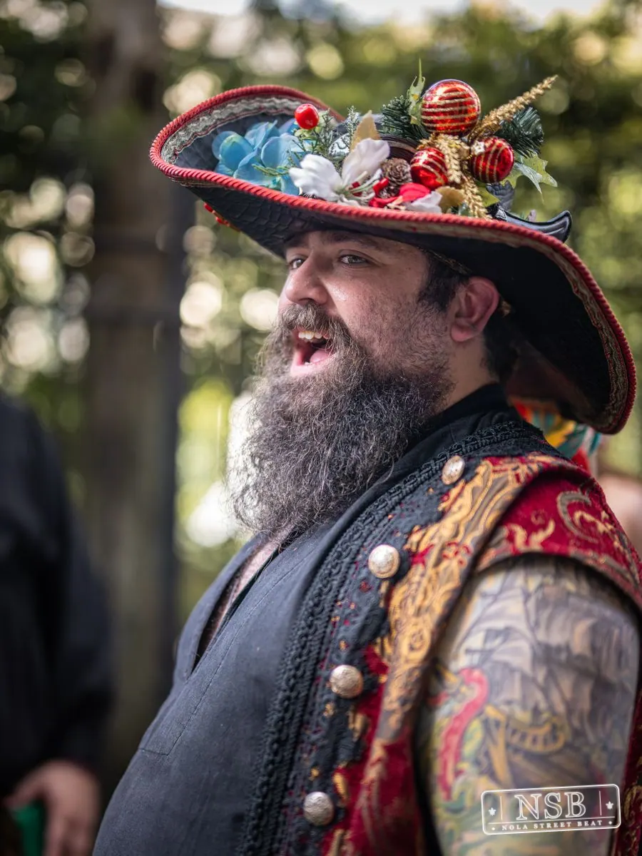 Bearded costumed attendee wearing an ornamented hat at Dirty Linen Night 2026