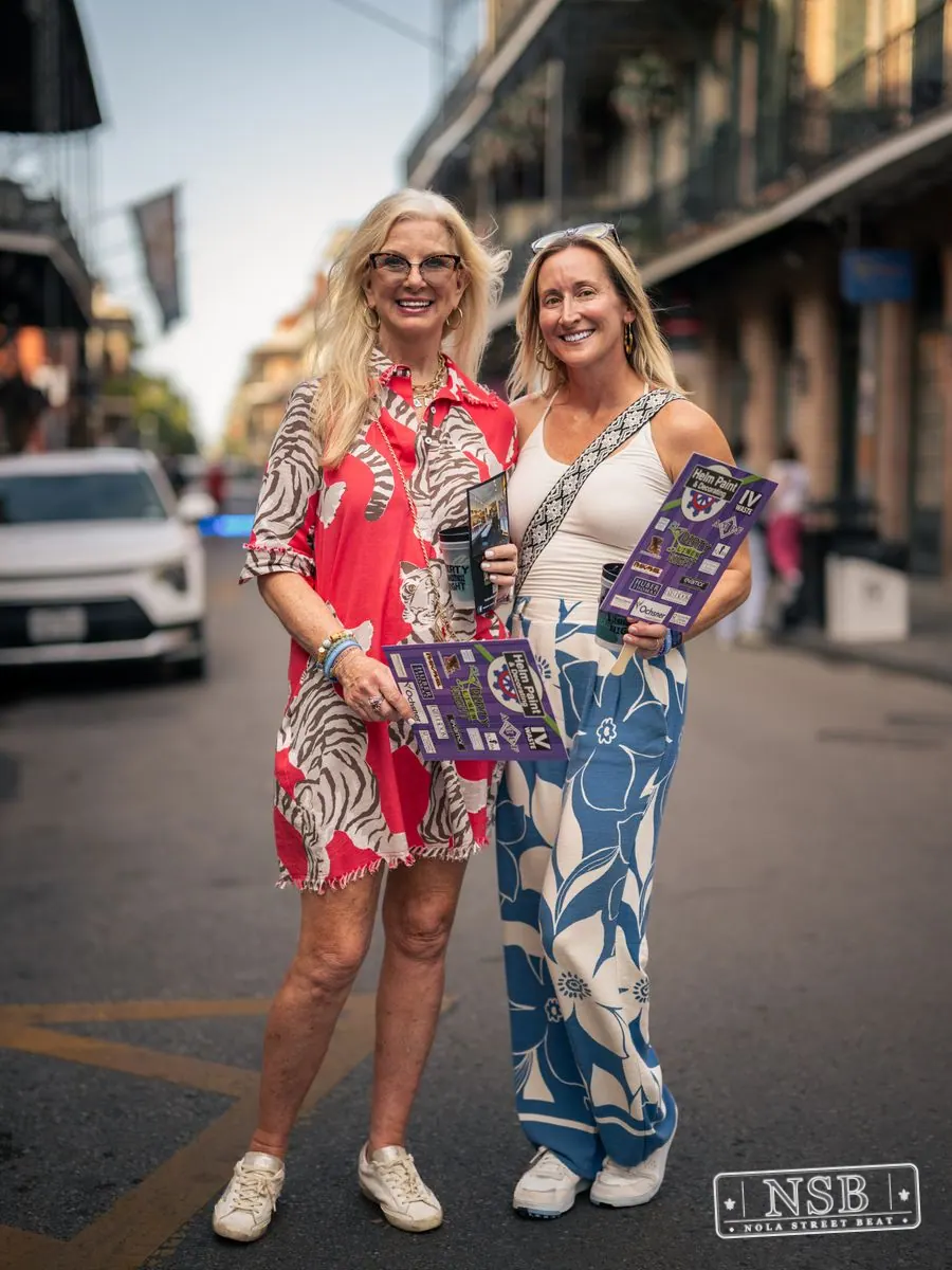 Two friends posing on Royal Street during Dirty Linen Night 2026 in New Orleans