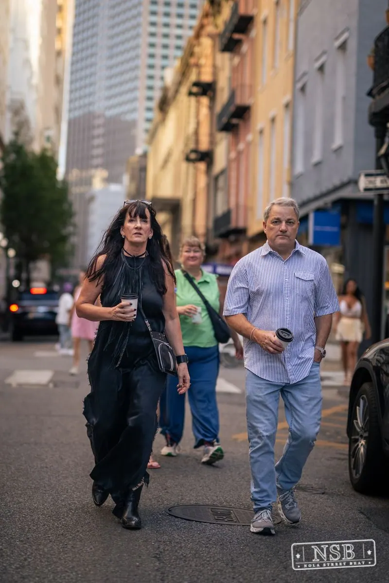 Couple walking together on Royal Street during Dirty Linen Night 2026