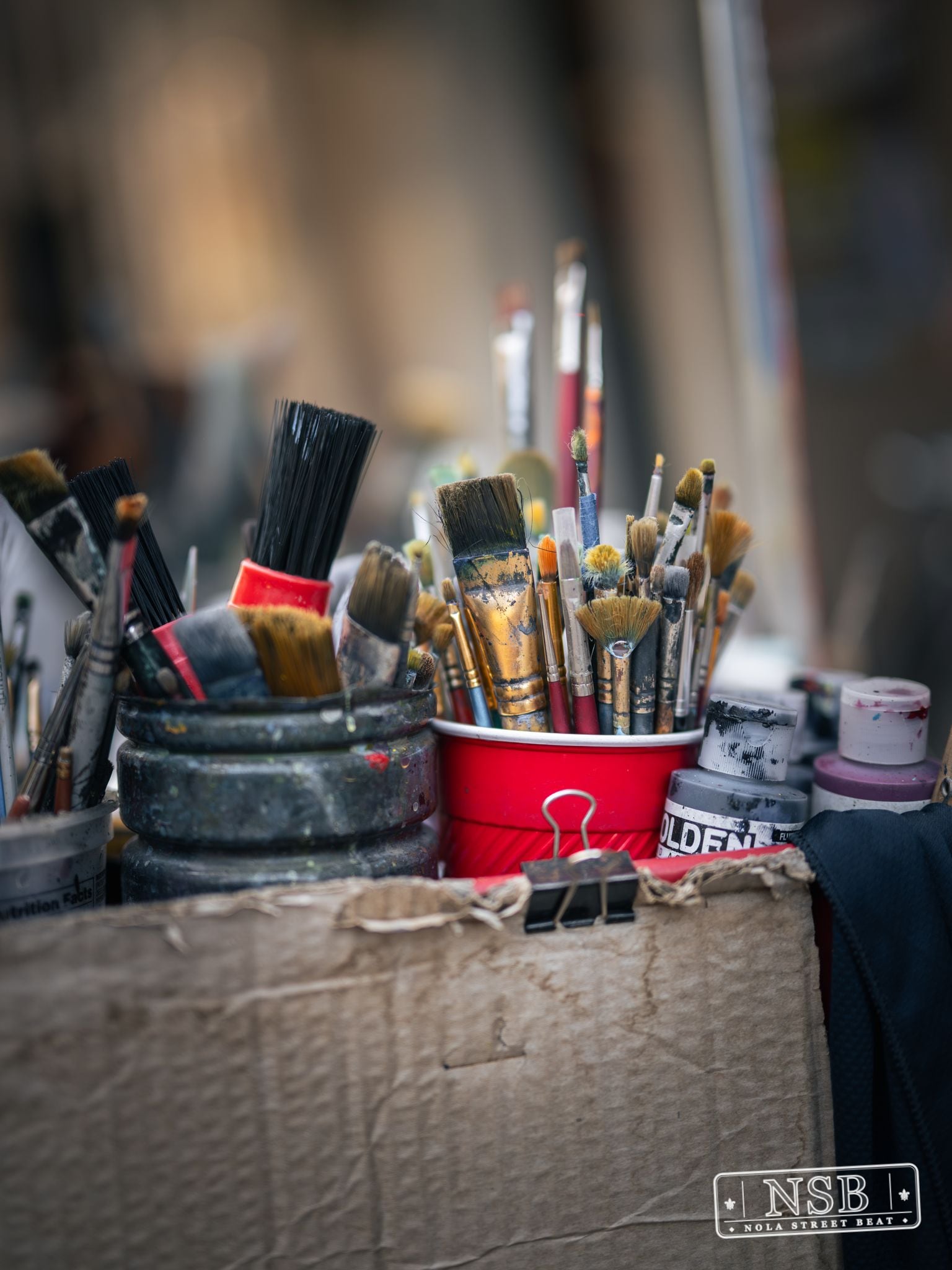 Paintbrushes and art supplies displayed during Dirty Linen Night 2026 on Royal Street