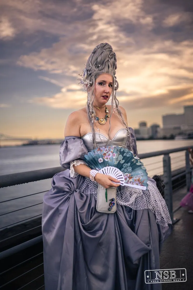 A participant in a lavender sea-inspired gown and elaborate crown at the 2026 New Orleans Mermaid Parade