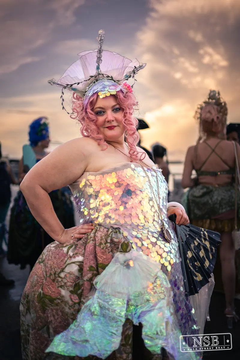 A participant in a pastel mermaid costume and decorative headpiece at the 2026 New Orleans Mermaid Parade