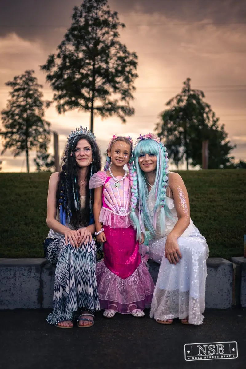 Three costumed friends posing together before the parade at the 2026 New Orleans Mermaid Parade