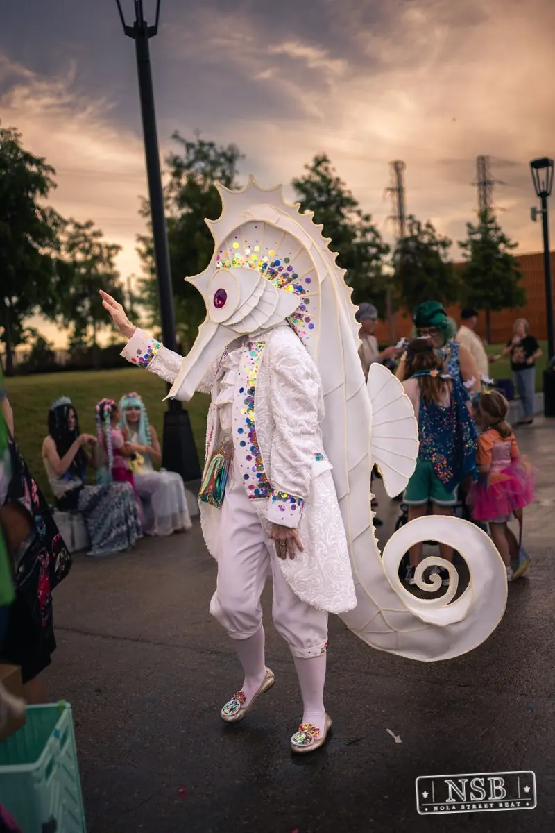 A white seahorse costume among the Mermaid Parade crowd at the 2026 New Orleans Mermaid Parade