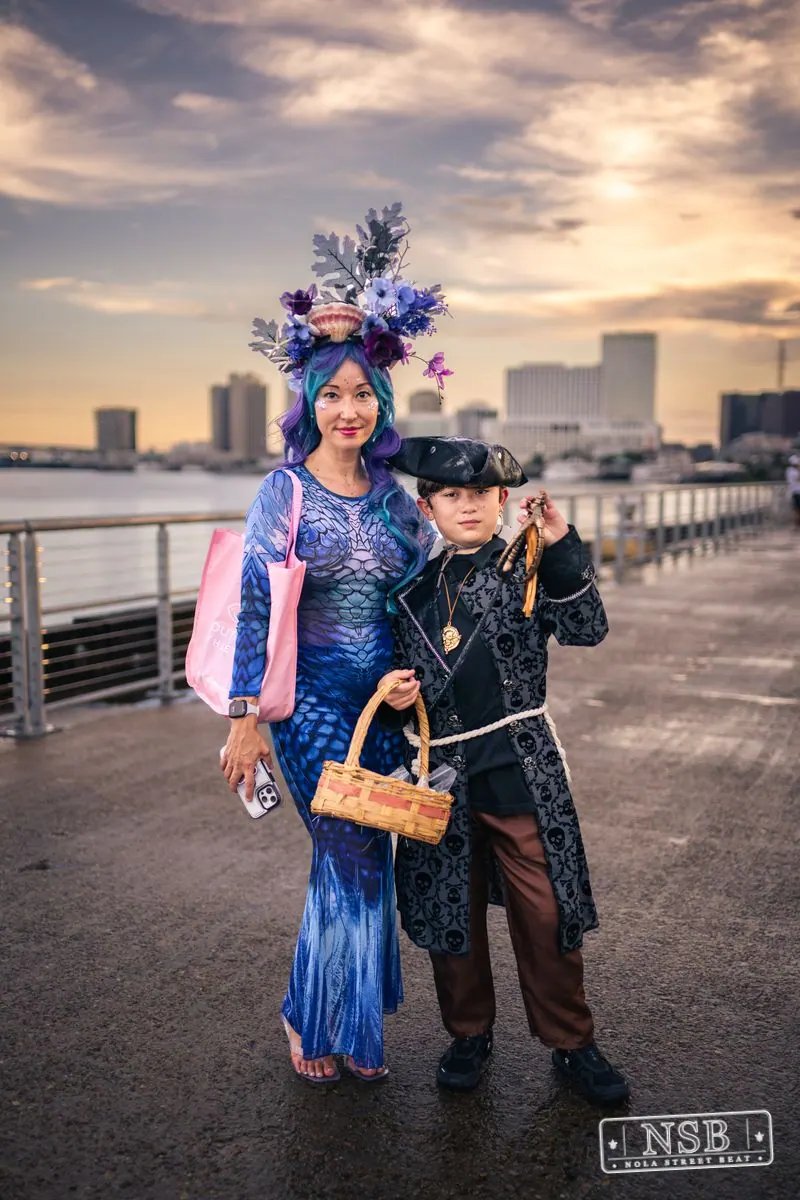 A participant wearing an elaborate blue sea-inspired costume at the 2026 New Orleans Mermaid Parade