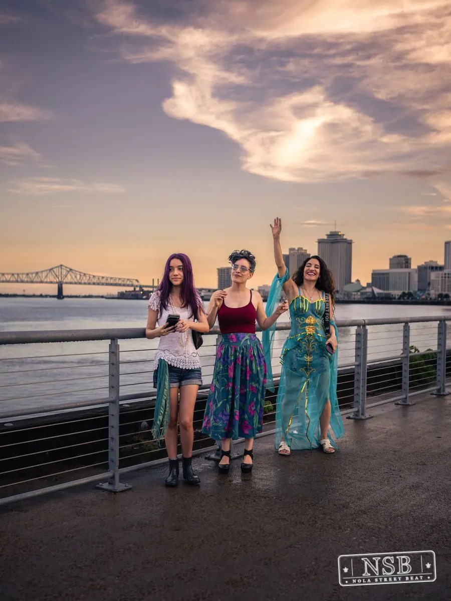 Costumed parade participants posing beneath the evening sky at the 2026 New Orleans Mermaid Parade