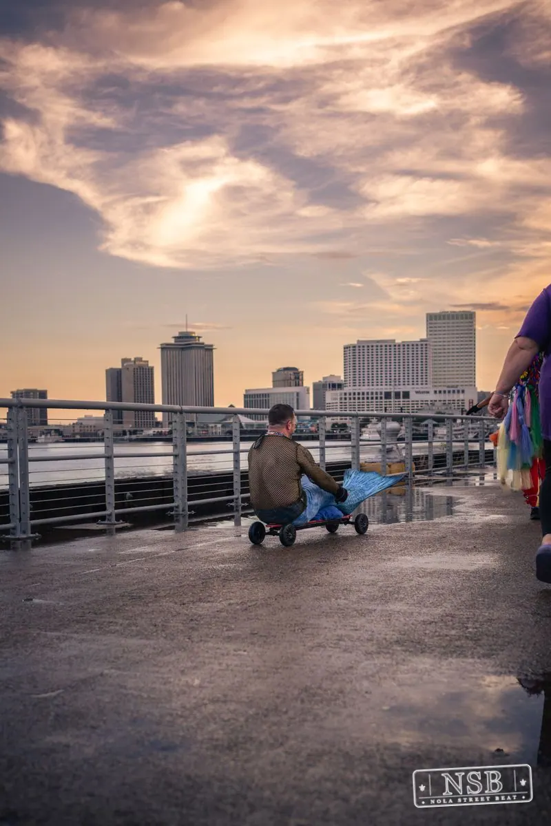 The New Orleans riverfront and skyline beneath a dramatic evening sky at the 2026 New Orleans Mermaid Parade