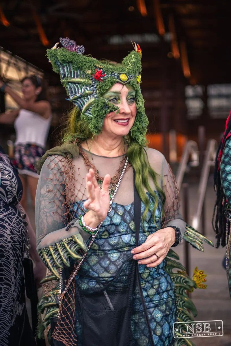A participant wearing a green sea-inspired crown at the 2026 New Orleans Mermaid Parade