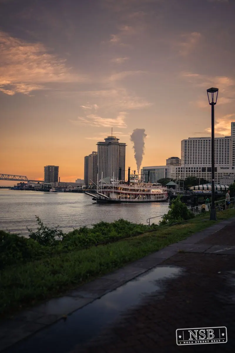 The Mississippi River and city skyline beneath the evening sky at the 2026 New Orleans Mermaid Parade