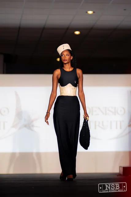 Black gown with beige corset and hat on the runway at New Orleans Fashion Week 2026. Photo 0003 by Nola Street Beat.