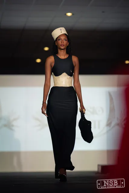Black gown with beige corset and hat on the runway at New Orleans Fashion Week 2026. Photo 0005 by Nola Street Beat.
