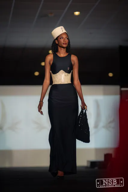 Black gown with beige corset and hat on the runway at New Orleans Fashion Week 2026. Photo 0006 by Nola Street Beat.