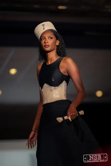 Black gown with beige corset and hat on the runway at New Orleans Fashion Week 2026. Photo 0012 by Nola Street Beat.