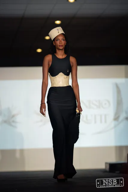 Black gown with beige corset and hat on the runway at New Orleans Fashion Week 2026. Photo 0016 by Nola Street Beat.