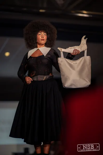 Black lace midi dress with white collar on the runway at New Orleans Fashion Week 2026. Photo 0028 by Nola Street Beat.