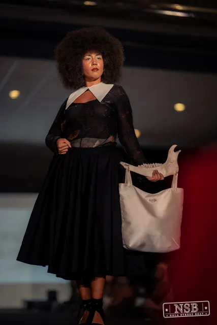 Black lace midi dress with white collar on the runway at New Orleans Fashion Week 2026. Photo 0029 by Nola Street Beat.