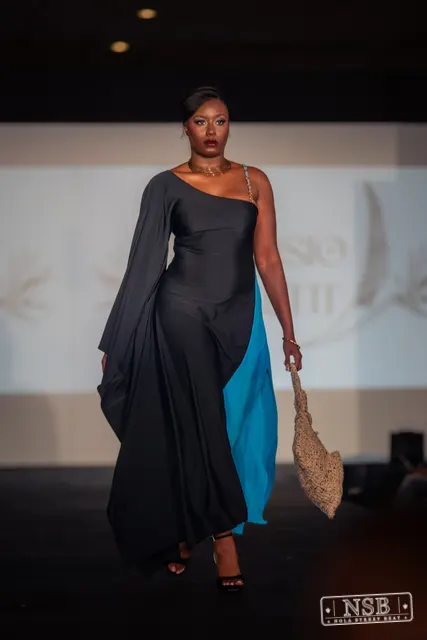 Draped black dress with turquoise panel on the runway at New Orleans Fashion Week 2026. Photo 0039 by Nola Street Beat.